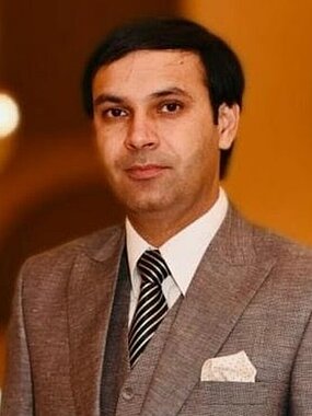 photo of Imdad Ullah wearing a suit 